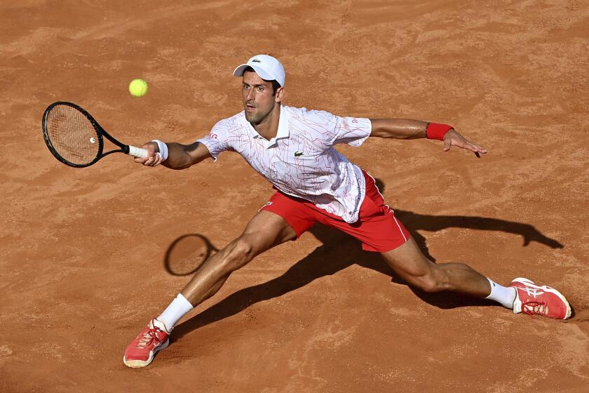 Serbia's Novak Djokovic returns the ball to Serbia's Filip Krajnovic during their Italian Open tennis tournament match, in Rome, Friday, Sept. 18, 2020. (Alfredo Falcone/LaPresse via AP)