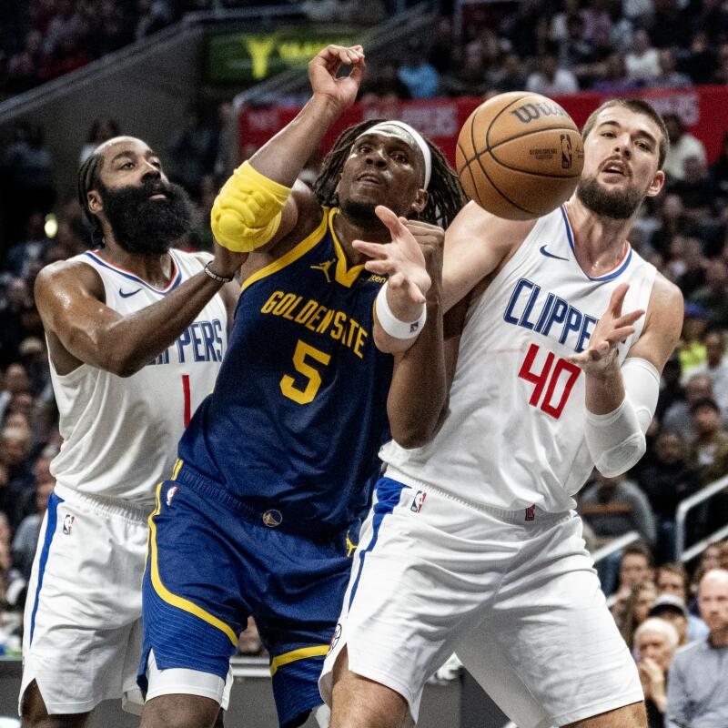 Clippers guard James Harden and center Ivica Zubac battle Warriors forward Kevon Looney for a rebound.