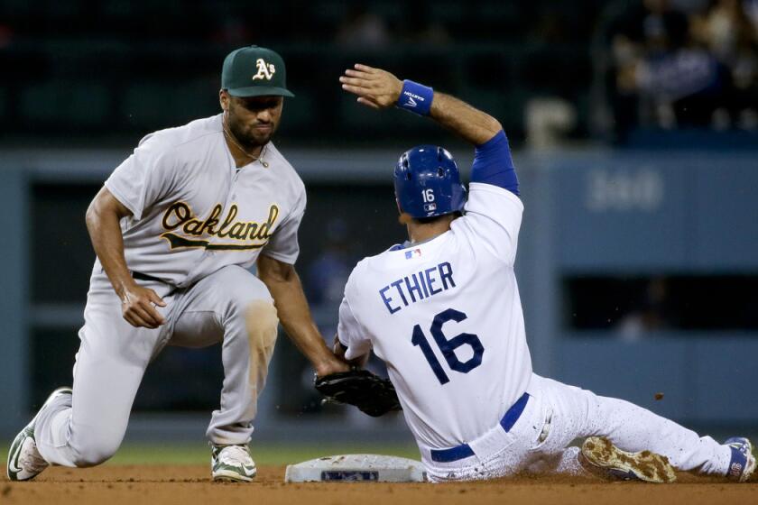 Los Angeles Dodgers' Andre Ethier, right, is tagged out stealing by Oakland Athletics shortstop Marcus Semien during the fifth inning on Tuesday.