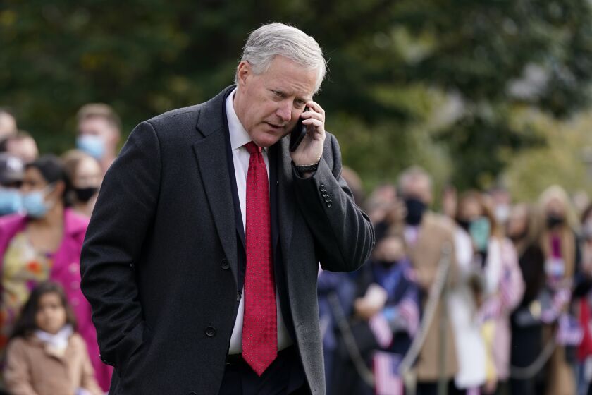 FILE - White House chief of staff Mark Meadows speaks on a phone on the South Lawn of the White House in Washington, on Oct. 30, 2020. The House committee investigating the Jan. 6 Capitol insurrection has issued almost three dozen subpoenas as it aggressively seeks information about the origins of the attack and what former President Donald Trump did — or didn’t do — to stop it. The panel is exploring several paths simultaneously. (AP Photo/Patrick Semansky, File)