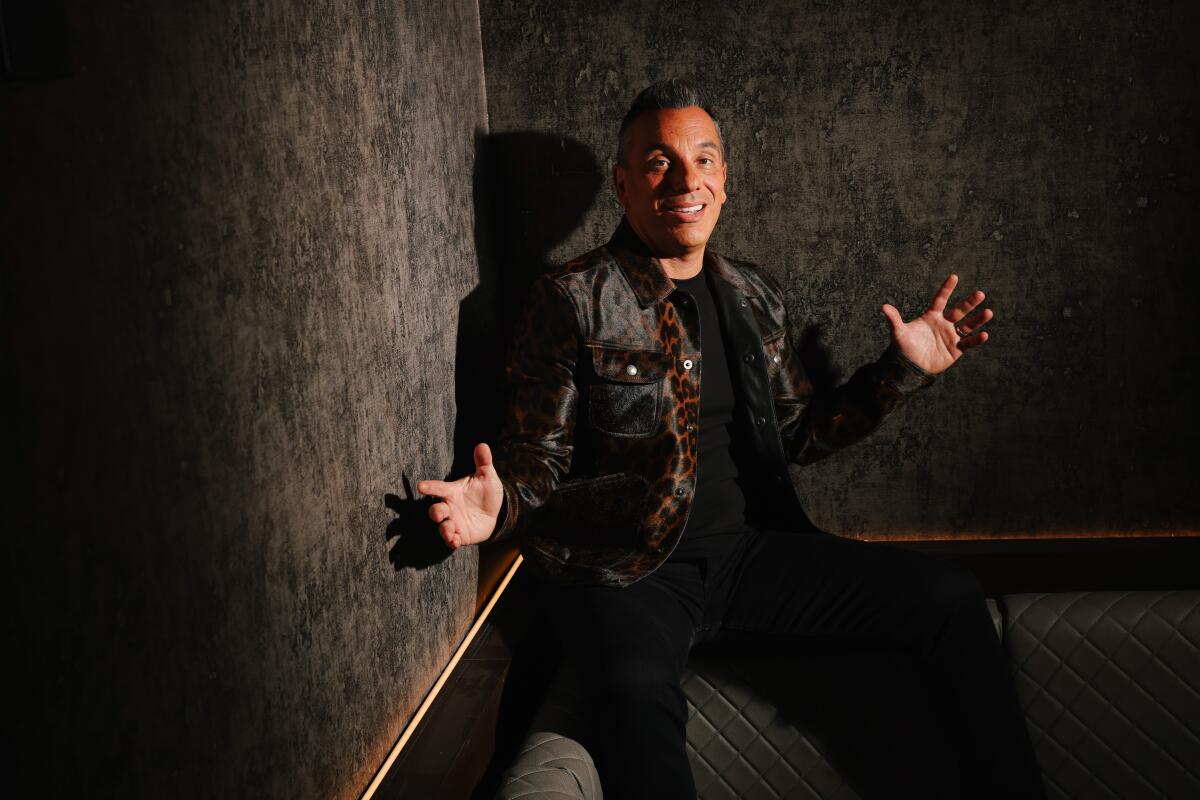 Man sitting in booth with leopard jacket