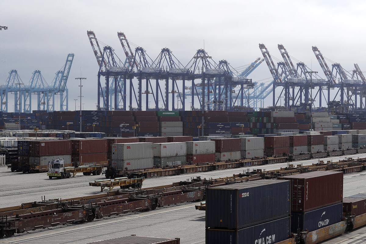 Cargo containers and oil rigs at a port.