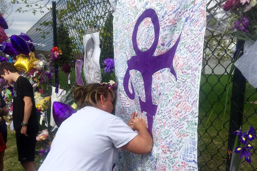 Fans outside Paisley Park in Chanhassen, Minn., left messages on a memorial sheet adorned with the symbol Prince once used to identify himself.