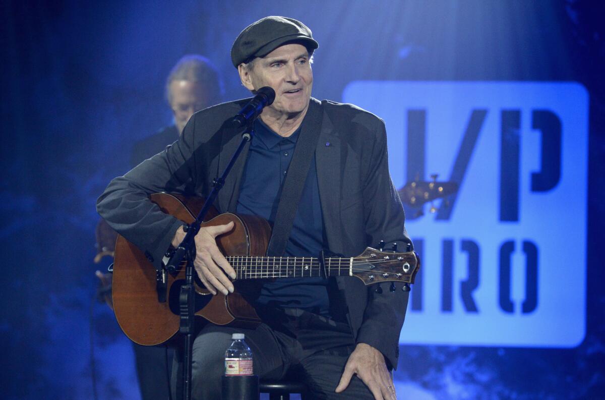 James Taylor delivers a surprise performance at the benefit.