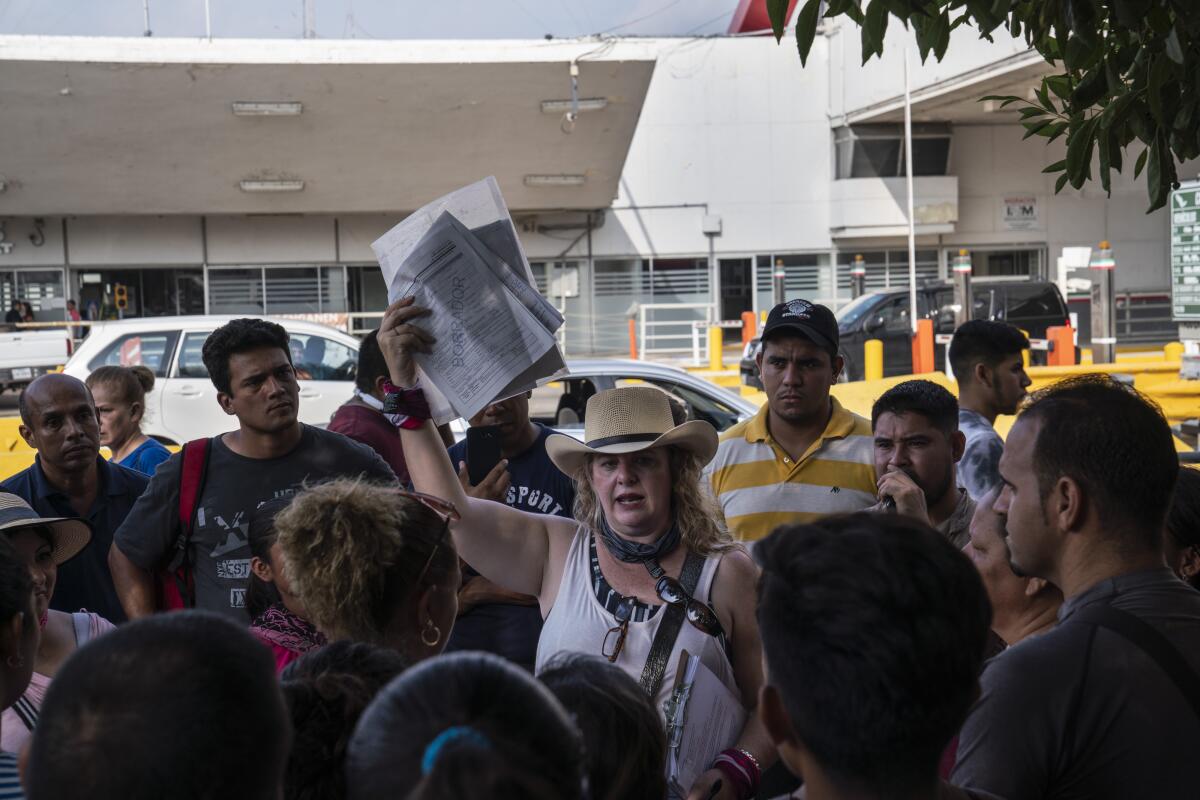 Texas-based immigration lawyer Jodi Goodwin, center, informs asylum seekers sent back to Matamoros from the U.S. under the "Remain in Mexico" policy of their rights during a visit to the Mexican border city on Aug. 24, 2019. The Atlanta-based nonprofit Lawyers for Good Government flew half a dozen immigration lawyers from across the country to help Goodwin prepare asylum seekers for upcoming immigration court hearings in Texas.