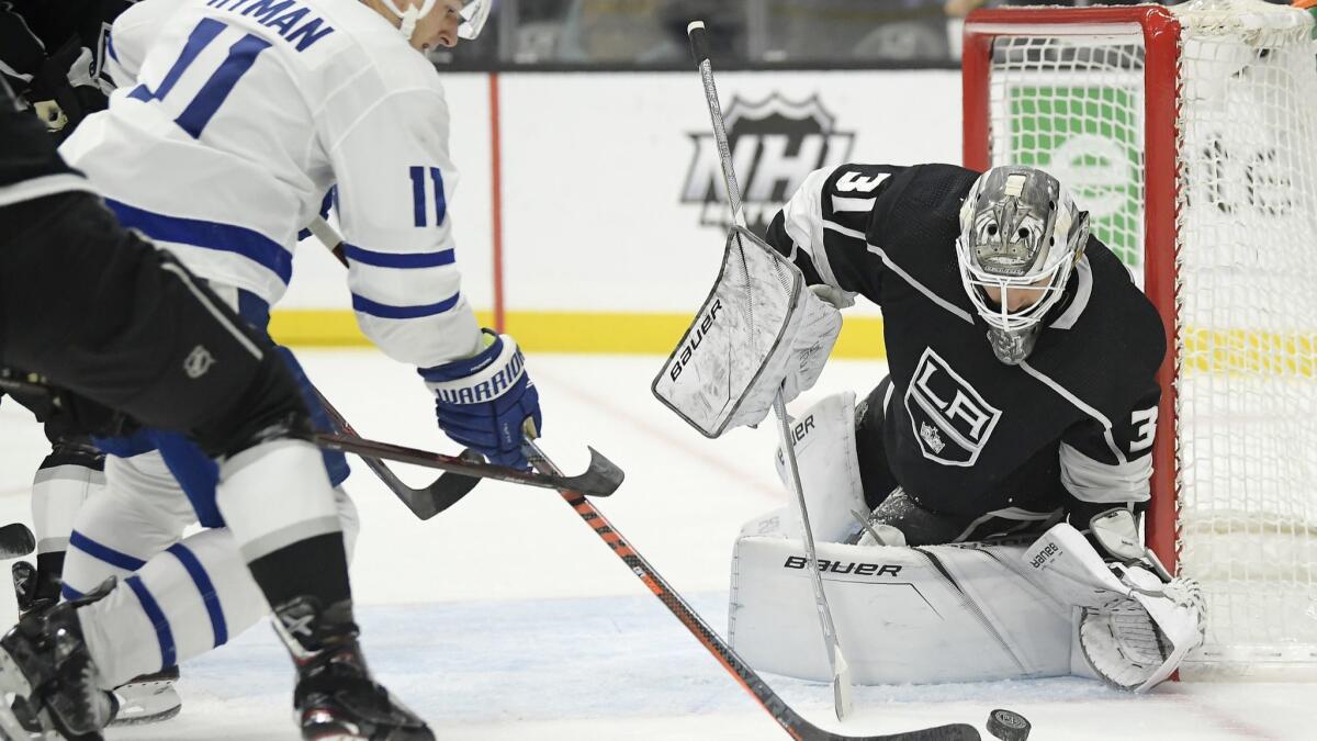 Toronto Maple Leafs left wing Zach Hyman, left, tries to get a shot past Kings goaltender Peter Budaj, of Slovakia, during the first period.