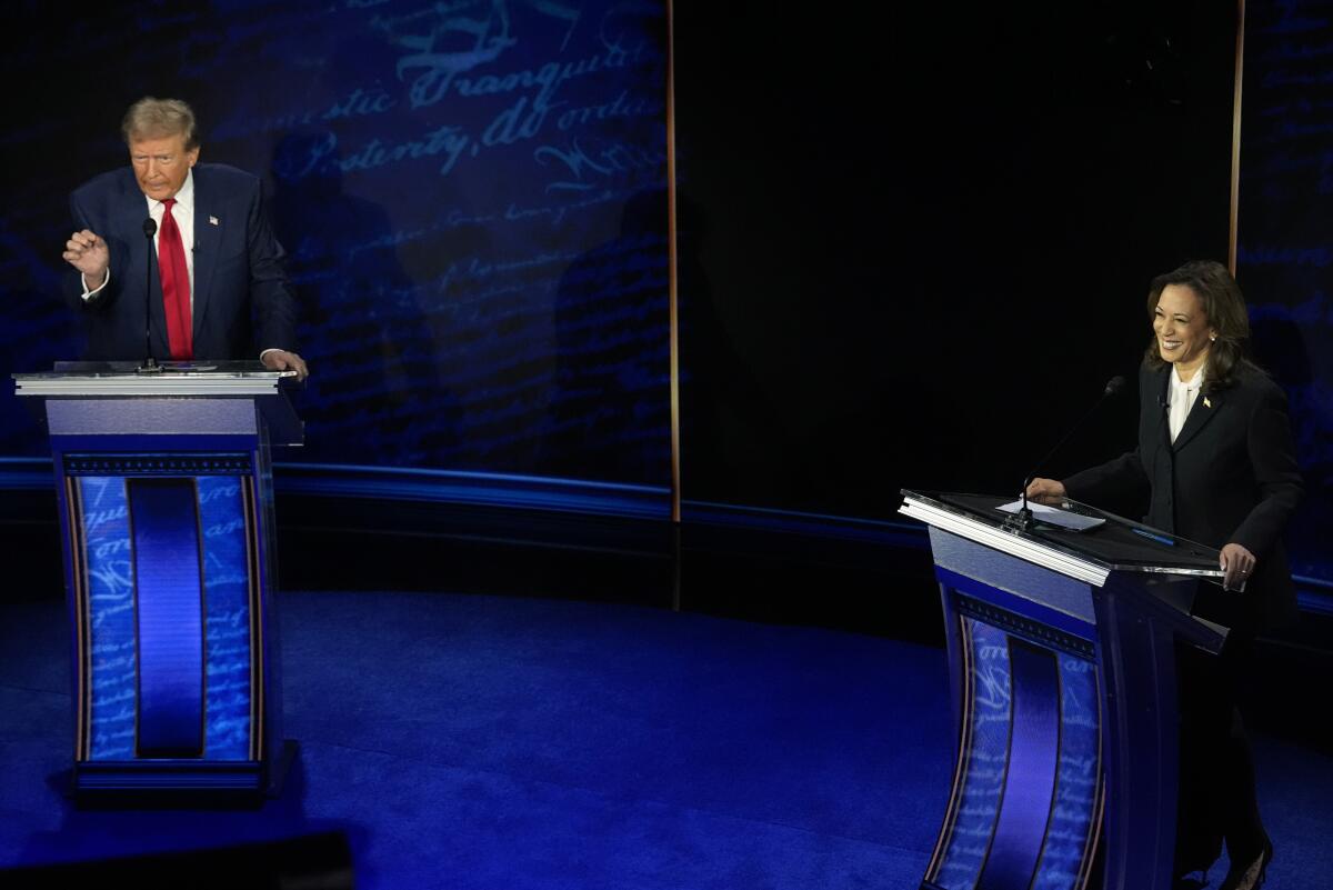 Kamala Harris smiles behind her lectern as Donald Trump speaks angrily.