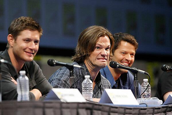 Jared Palalecki, center, jokes with the audience and makes a face when a question is asked of Jensen Ackles, left, during the "Supernatural" panel during Comic-Con at the San Diego Convention Center. Also present is Misha Collins, right.