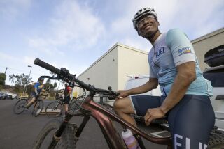 ENCINITAS, CA - JUNE 9, 2022: Robert Duran, 55, who has had pancreatic cancer since 2014, sits on his trail bike as he and friends gather at El Camino Bike Shop in Encinitas to go for a 15 mile bike ride together after Duran's weekly chemotherapy treatment on Thursday, June 9, 2022. (Hayne Palmour IV / For The San Diego Union-Tribune)