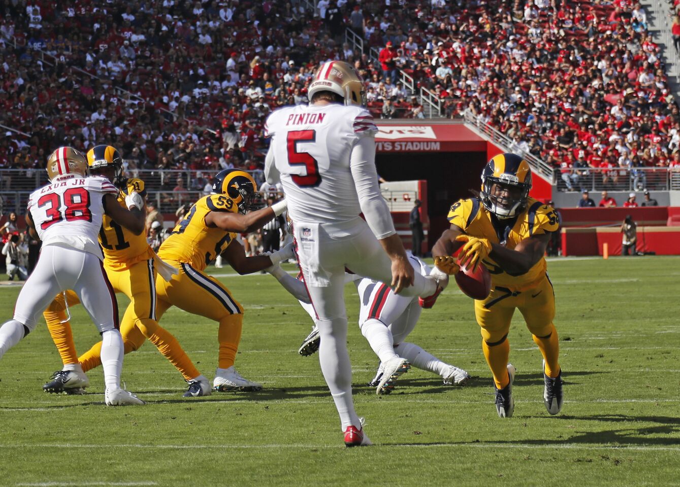 Rams linebacker Cory Littleton (58) blocks a punt by San Francisco 49ers punter Bradley Pinion (5) which led to a safety in the first half at Levi's Stadium on Sunday in Santa Clara.