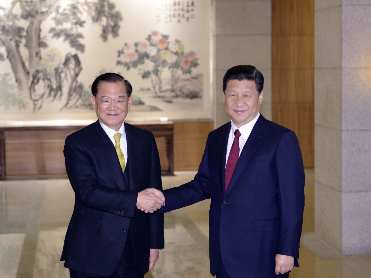 Chinese President Xi Jinping, right, shakes hands with Lien Chan, honorary chairman of the Taiwanese Nationalist Party and a former premier and vice president of Taiwan, at the Diaoyutai State guest house in Beijing.