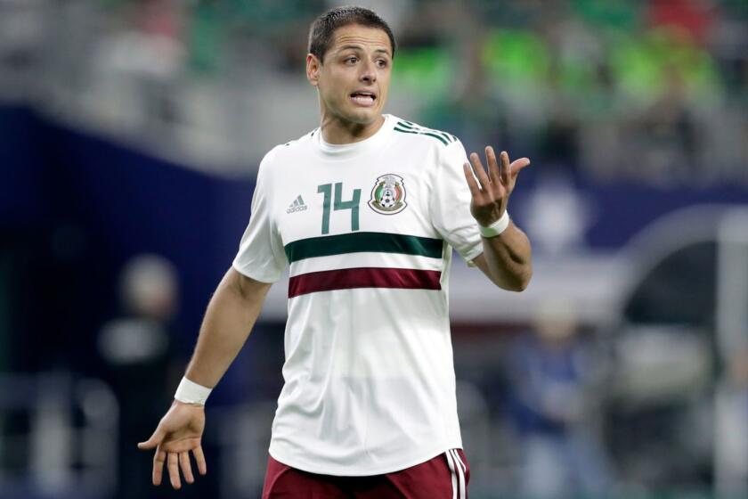 In this image taken on Tuesday, March 27, 2018 Mexico forward Javier Hernandez jogs across the field talking to an official, not pictured, during a international friendly soccer match against Croatia in Arlington, Texas, Tuesday, March 27, 2018. (AP Photo/Tony Gutierrez)