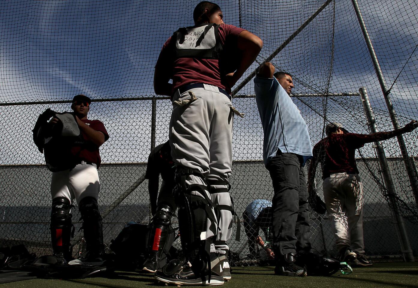 Baseball umpire trainees gear up for an instructional camp session at the batting cages at Compton Community College. The camp is operated by Major League Baseball and serves as a way to find and groom future major league officials.
