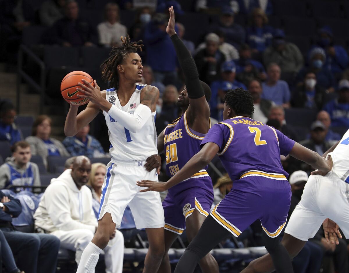 Tennessee Tech's John Pettway center, defends as Memphis Emoni Bates looks for an outlet in the first half of an NCAA college basketball game Tuesday, Nov. 9, 2021, in Memphis, Tenn. (AP Photo/Karen Pulfer Focht)