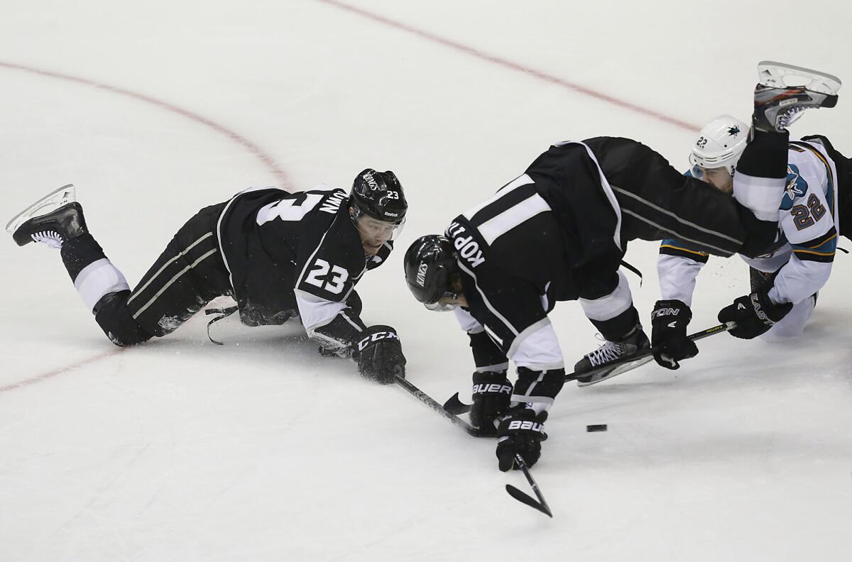 Dustin Brown, left, and Anze Kopitar, center, will be together again on the ice for the Kings tonight.