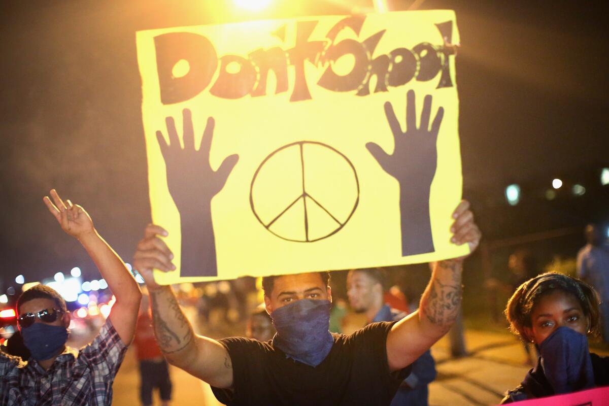 Demonstrators hold up a "Don't shoot" sign during an Aug. 17 protest over the killing of Michael Brown in Ferguson, Mo.