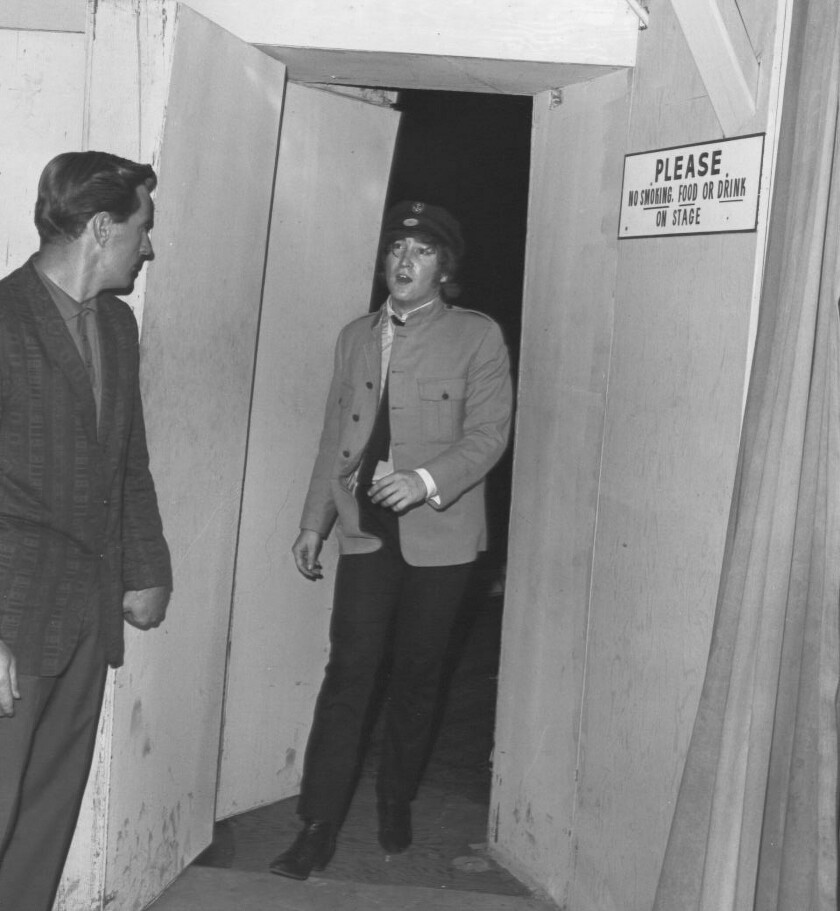 John Lennon exiting from the backstage door of the Hollywood Bowl, Aug. 23, 1964.