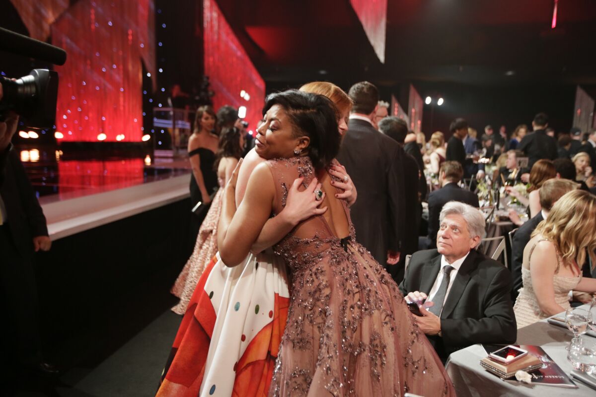 Taraji P. Henson receives a hug during the show.