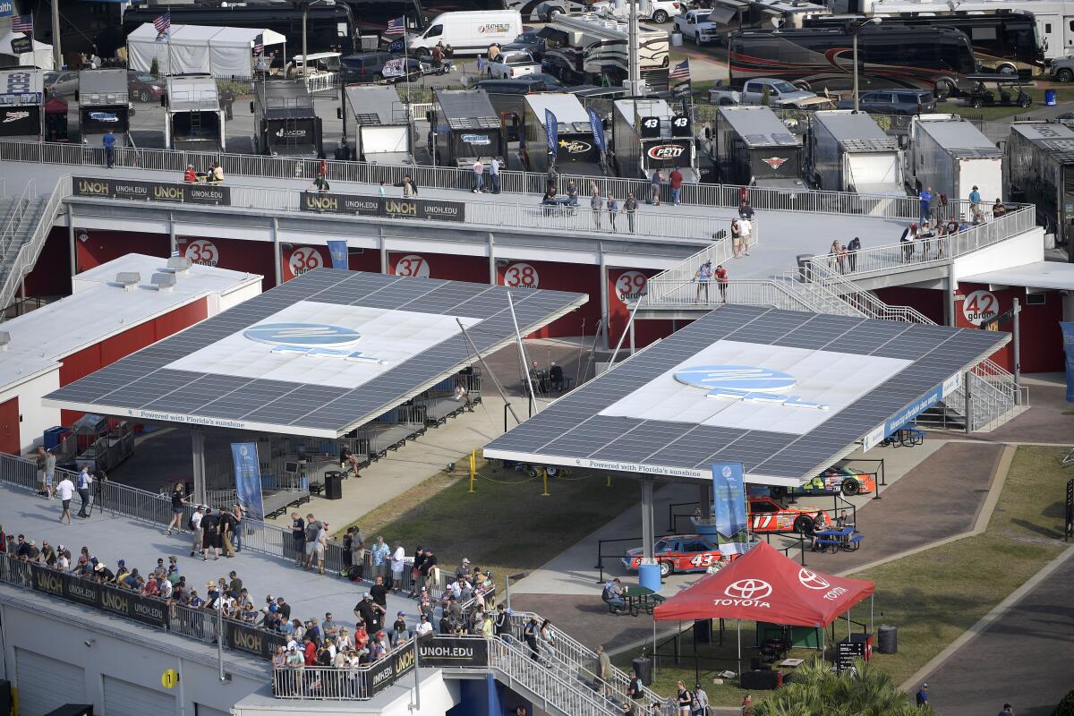 Solar arrays help power the Florida Power & Light Solar Circuit and provide shade in the infield during a NASCAR Xfinity Series auto race at Daytona International Speedway, Feb. 16, 2019, in Daytona Beach, Fla. Florida’s largest electric provider has announced plans to eliminate all of its carbon emissions by 2045 by increasing its reliance on solar energy, including using it to turn water into hydrogen to fuel its power plants. Florida Power & Light says the multibillion dollar plan will not result in any price increases beyond what would be anticipated normally for its nearly 6 million customers. (AP Photo/Phelan M. Ebenhack)