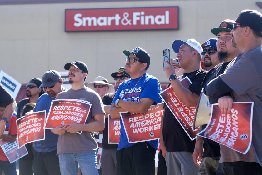 Members of Smart & Final Warehouse Workers, holding signs protest during a press conference outside Smart & Final Super Market in Burbank, California, on Wednesday August 16, 2023. More than 600 Smart & Final warehouse workers recently became members of Teamsters Local 630 accuse parent company Mexican-Owned Grupo CHEDRAUI, USA given working, pay, and safety conditions create by the company since they took ownership. The company announced expansion plans and plans create wage disparities as company announces expansion plans in the Western States. (Photo by Ringo Chiu / For The Times)