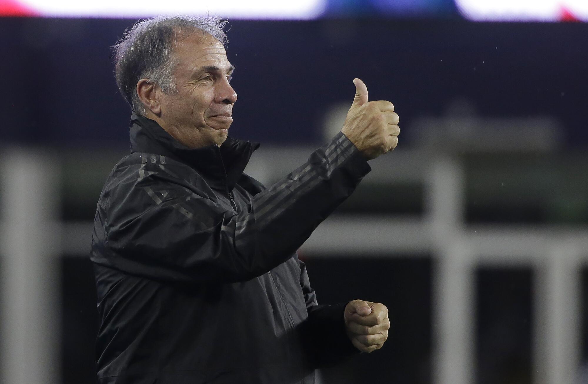 Revolution coach Bruce Arena gives a thumbs up after his team scored against the Whitecaps 