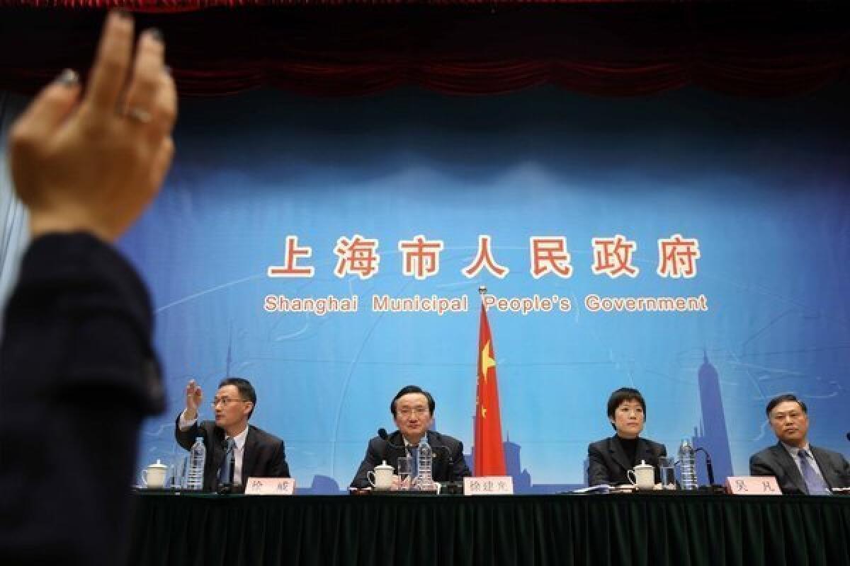 Officials in Shanghai addressed questions about the H7N9 bird flu. At least two people have died after infection with the virus, which has previously affected only birds.
