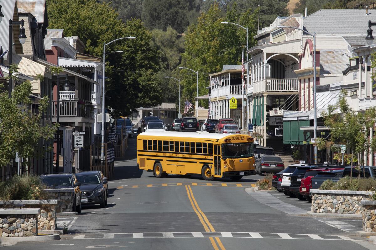 A school bus passes through downtown Sutter Creek, Calif.