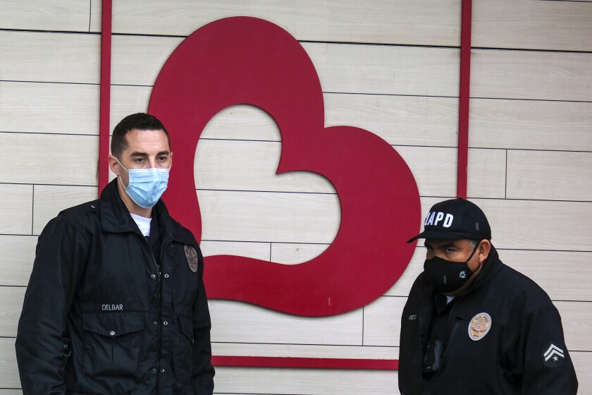 L.A. police officers stand outside the Burlington store in North Hollywood after Thursday's deadly shooting.