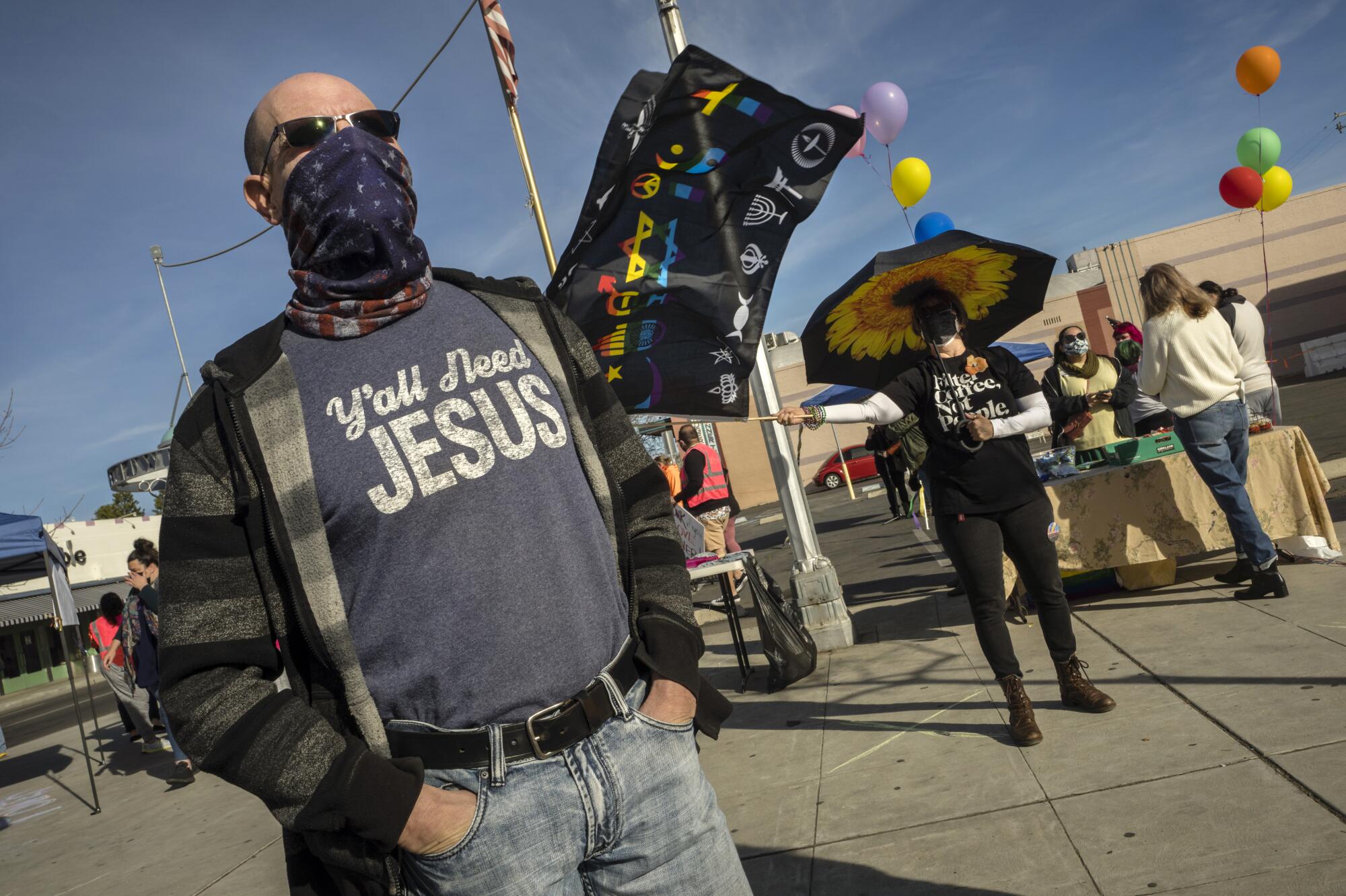 A man in a mask and a shirt that says Y'all need Jesus