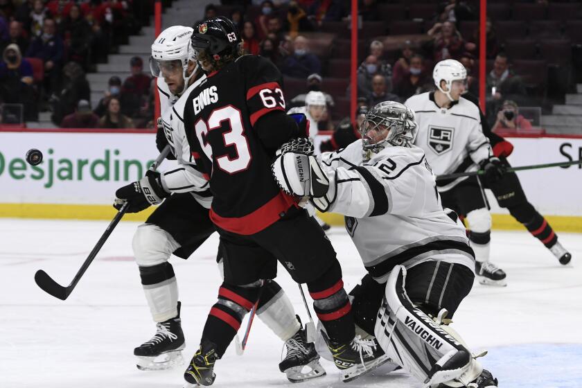 Los Angeles Kings goaltender Jonathan Quick (32) pushes back Ottawa Senators' Tyler Ennis (63) out of the crease.