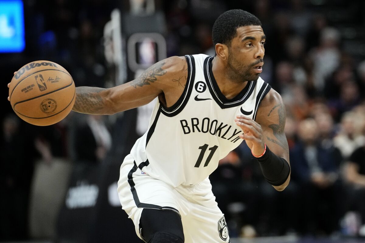 Brooklyn Nets guard Kyrie Irving drives to the basket January 19 during a game against the Phoenix Suns.