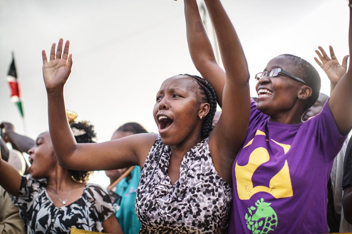 Crowds cheer from the roadside as Pope Francis' motorcade drives through Nairobi, Kenya, on Nov. 25.