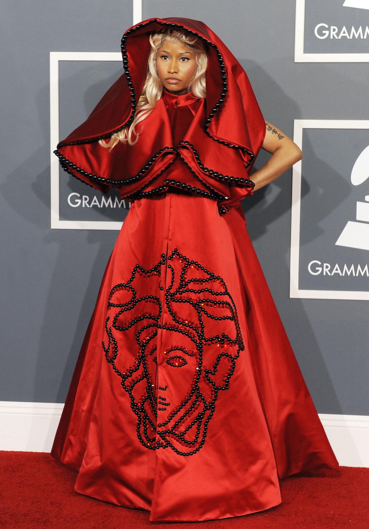 Nicki Minaj at the 2012 Grammy Awards in Los Angeles wearing a hooded scarlet red Versace ensemble.