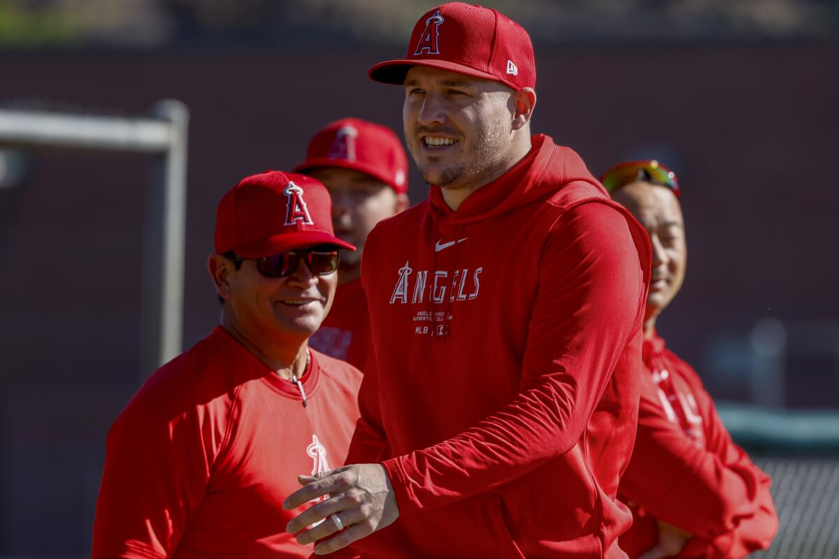 Angels star Mike Trout smiles at training camp on Monday.