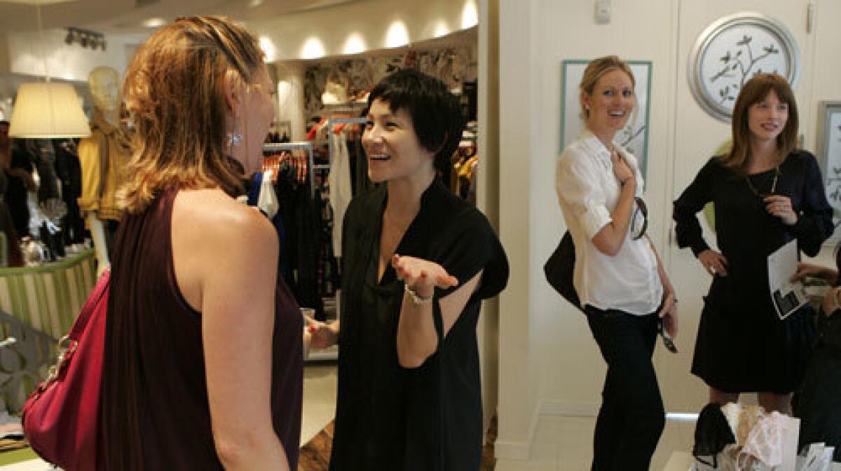 Daily Candy editors Crystal Meers, far right, and Eve Epstein, center, mingle with subscribers at a mixer in West Hollywoods Beckley boutique.