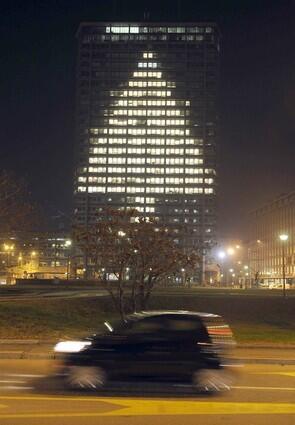 Italy An office building in central Milan leaves on lights to project the shape of a Christmas tree.