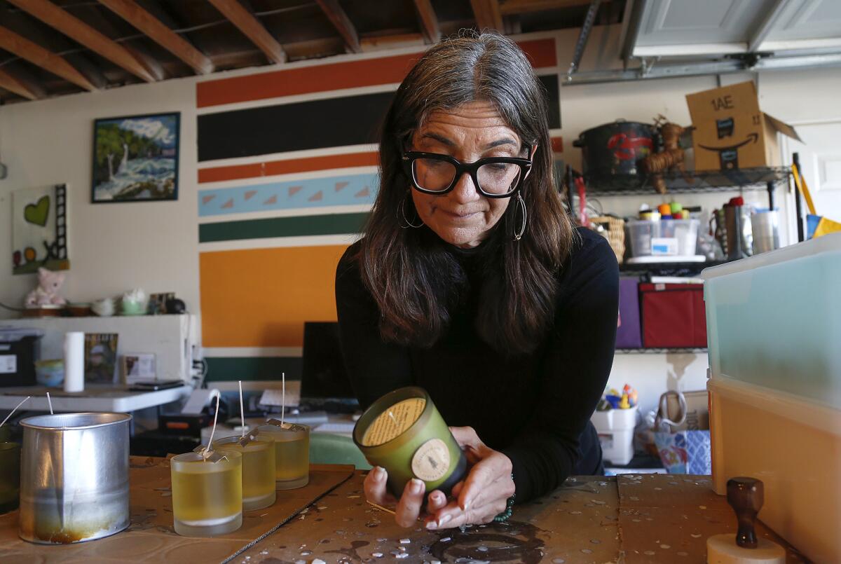 Kirsten "Kiki" Montgomery hand pours candles in her home studio in Laguna Beach.