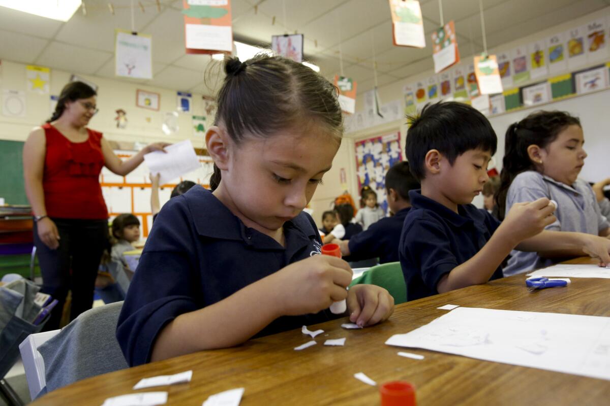 Kindergarten teacher Claudia Garcia, left, gives instructions as students work on projects at Magnolia Science Academy #7 in Northridge, which is one of three schools ordered shut down by the L.A. Unified School District last year. The school board has dropped efforts to shut the schools down.