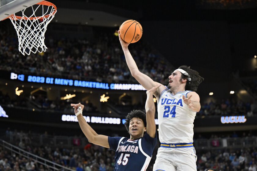 UCLA's Jaime Jaquez Jr. (24) shoots while defended by Gonzaga's Rasir Bolton (45) in the first half of a Sweet 16 college basketball game in the West Regional of the NCAA Tournament, Thursday, March 23, 2023, in Las Vegas. (AP Photo/David Becker)