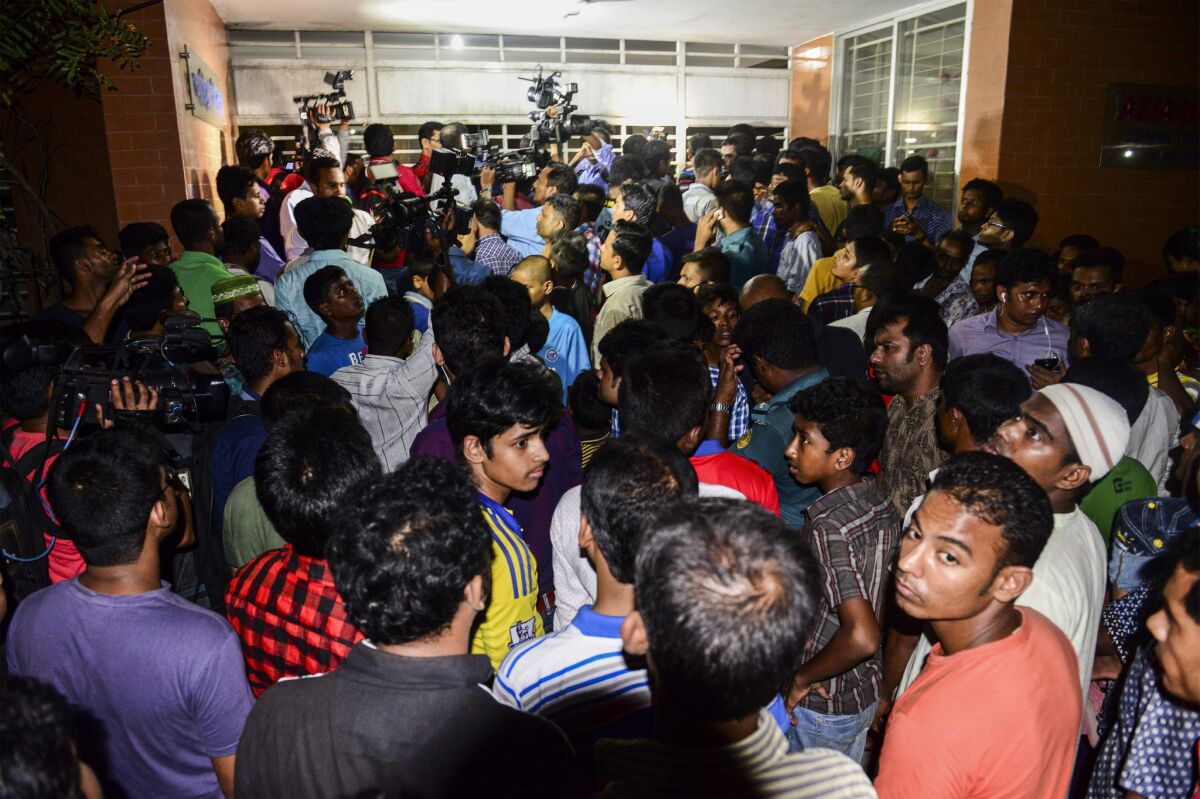 A crowd gathers outside the apartment building in Dhaka where Xulhaz Mannan, editor of Bangladesh's only LGBT magazine, was killed.