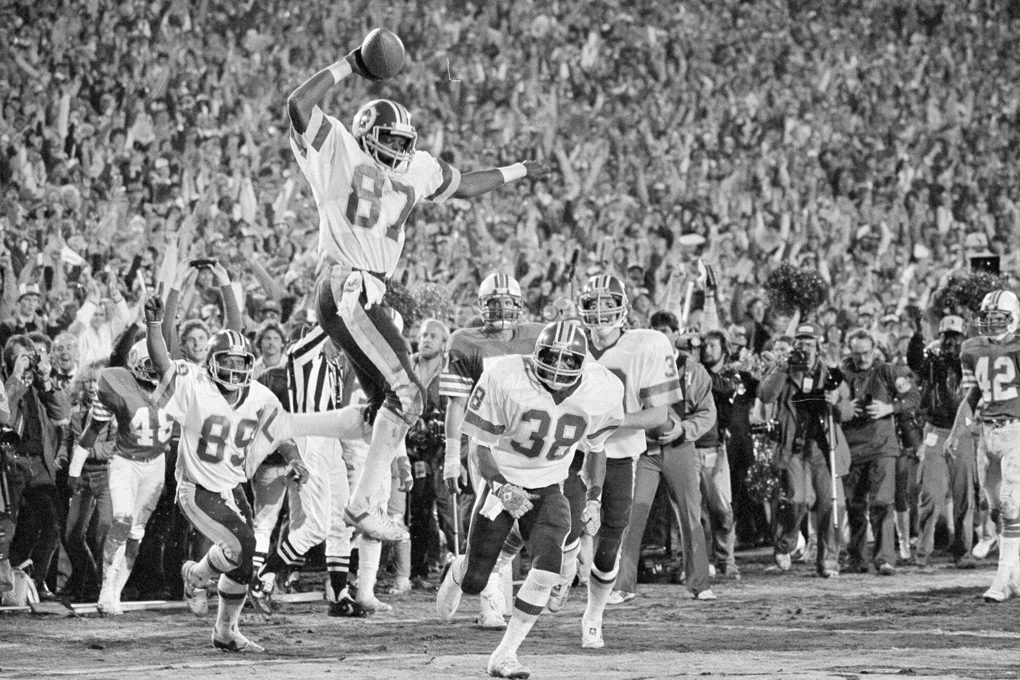 Washington receiver Charlie Brown (87) gets ready to spike the ball after he scored a fourth quarter touchdown