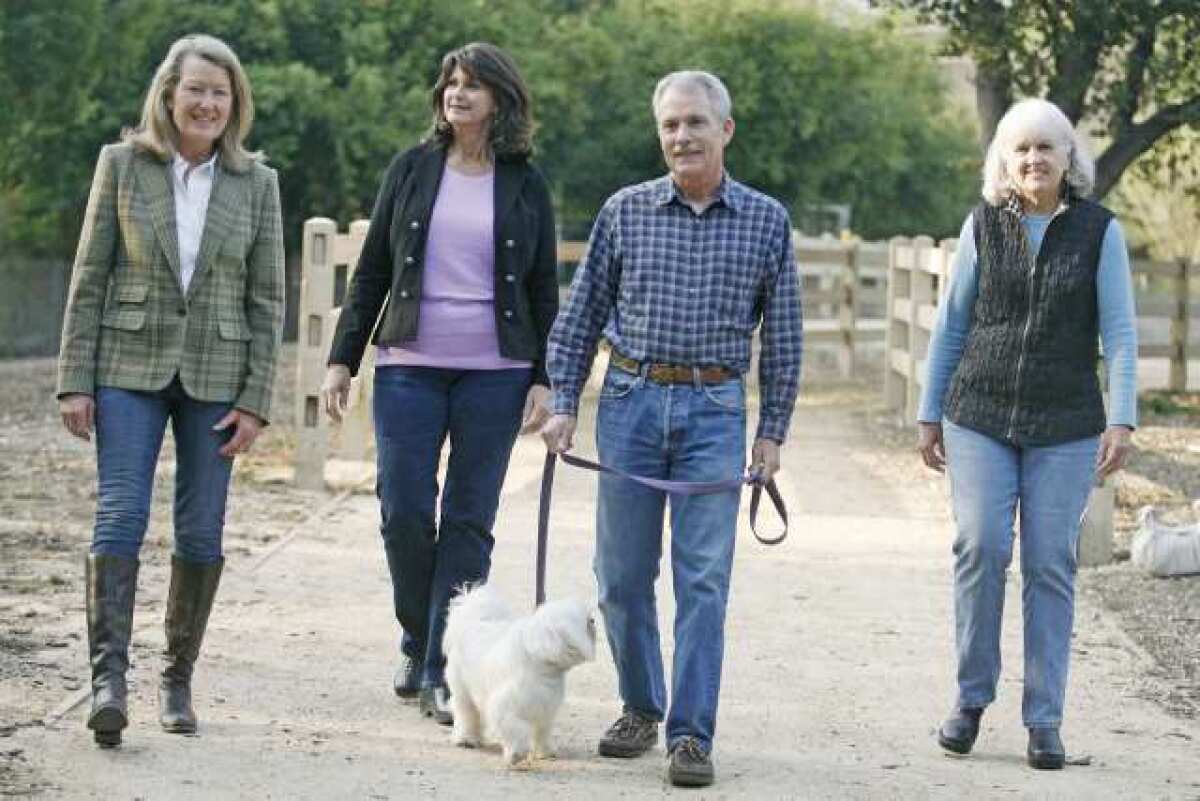 Council members Randy Strapazon, from left, Debbie Tinkham, President Ted Stork and Mary Barry walk on the Trails Council Link in La Canada.