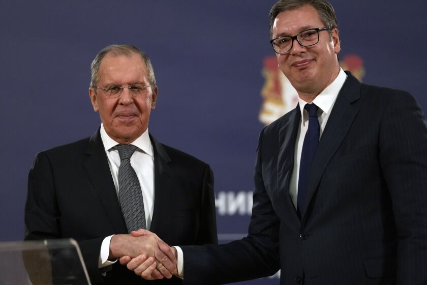 FILE - Russian Foreign Minister Sergey Lavrov, left, shakes hands with Serbia's President Aleksandar Vucic after a press conference in Belgrade, Serbia, Sunday, Oct. 10, 2021. European Union candidate Serbia has signed an agreement with Russia to hold mutual “consultations” on foreign policy matters. Serbian Foreign Affairs Minister Nikola Selakovic signed the agreement with Russian Foreign Minister Sergey Lavrov on the margins of the U.N. General Assembly. (AP Photo/Darko Vojinovic, File)