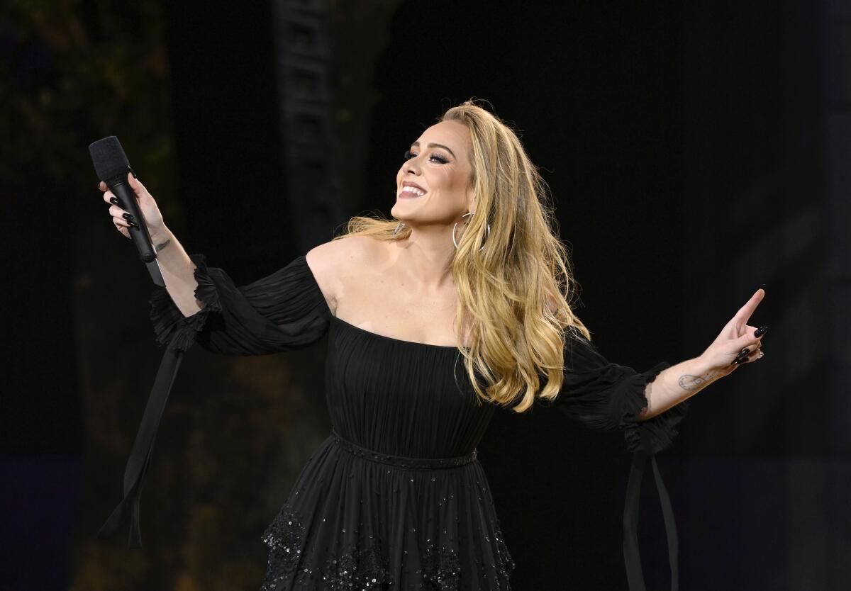 Adele performing live on stage with her fans cheering