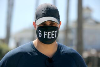 Marcos Escutia, 30 of Costa Mesa, wears a unique face mask at the Newport Pier in Newport Beach on Thursday, May 7, 2020.