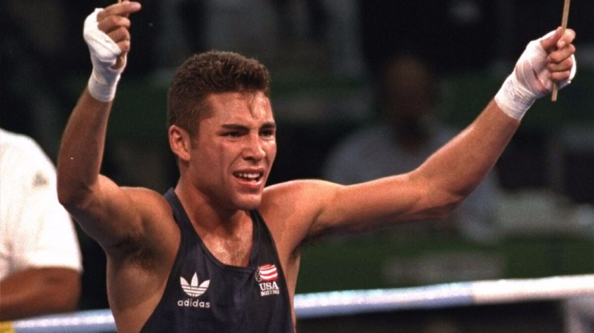 Oscar De Le Hoya celebrates after defeating Germany's Marco Rudolph for the lightweight division gold medal at the 1992 Olympics in Barcelona.