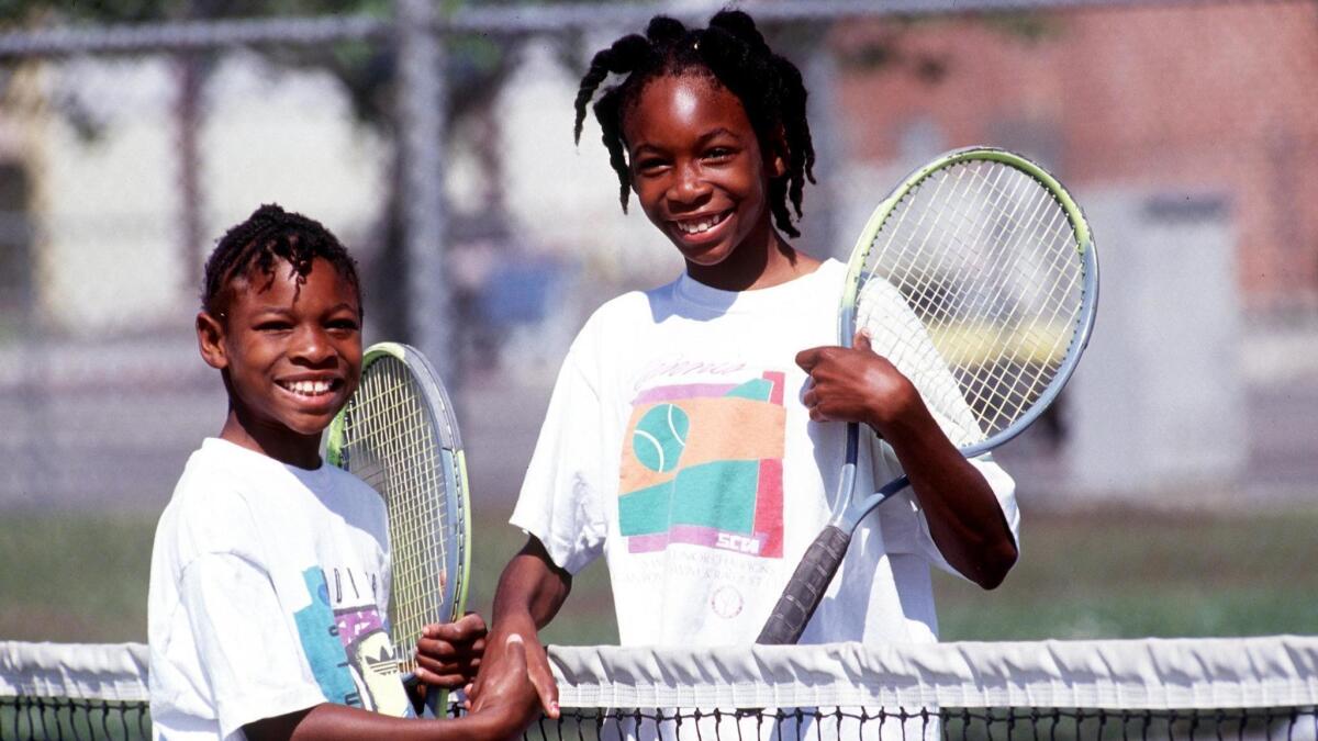 Sisters Serena, left, and Venus Williams shake hands after a game 1991 in Compton.