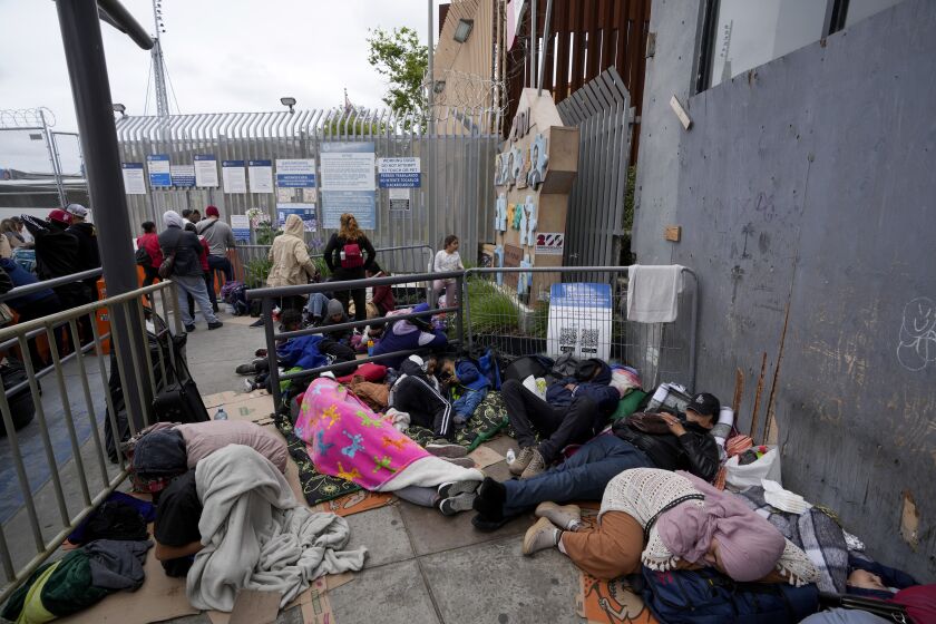 People waiting to apply for asylum camp near the pedestrian entrance to the San Isidro Port of Entry, linking Tijuana, Mexico with San Diego, Thursday, June 1, 2023, in Tijuana, Mexico. U.S. authorities raised the number of people allowed to enter the country with an online app allows asylum-seekers to enter the country with appointments to 1,250 a day from 1,000 though demand still far outstrips supply. (AP Photo/Gregory Bull)