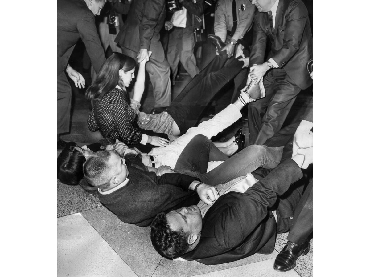 March 9, 1965: U.S. marshals drag sit-down demonstrators during melee in the lobby of the Federal Building in Los Angeles.