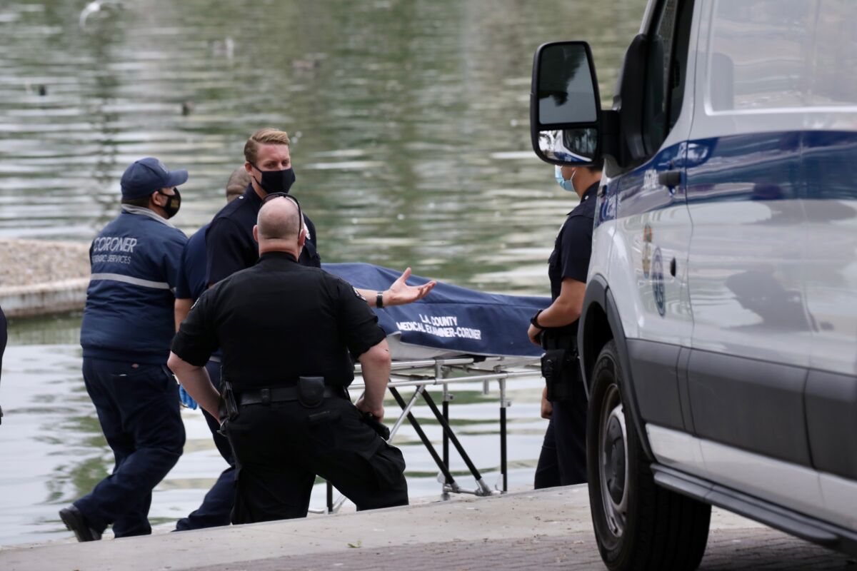An investigation is underway after a body was found in the lake at MacArthur Park Friday morning.